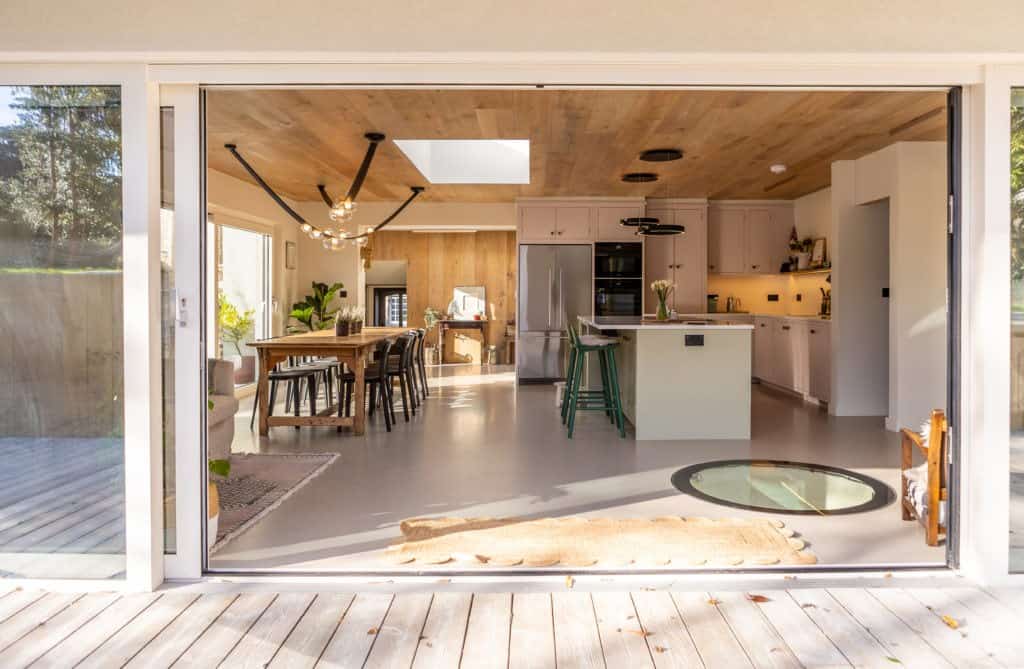 Open-plan kitchen and dining room opening onto a timber deck