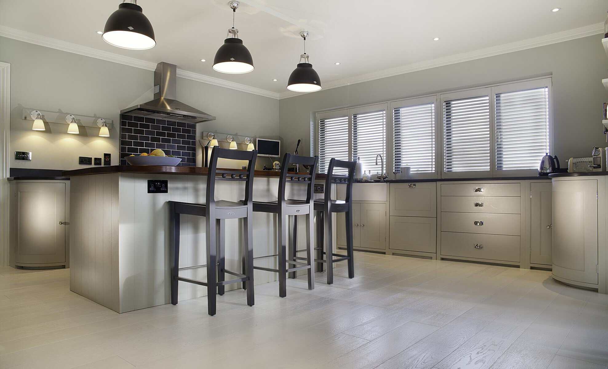 Painted kitchen with island, bar stools and pendant lights